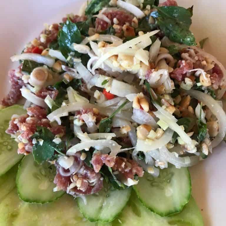 Fresh beef Salad on a plate served with cucumber slices