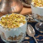 A sweet creamy dessert topped with pistachio nuts called esh asaraya