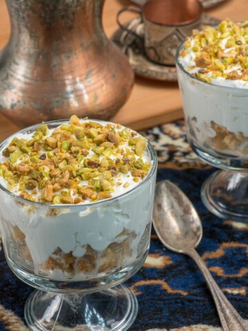 A sweet creamy dessert topped with pistachio nuts called esh asaraya