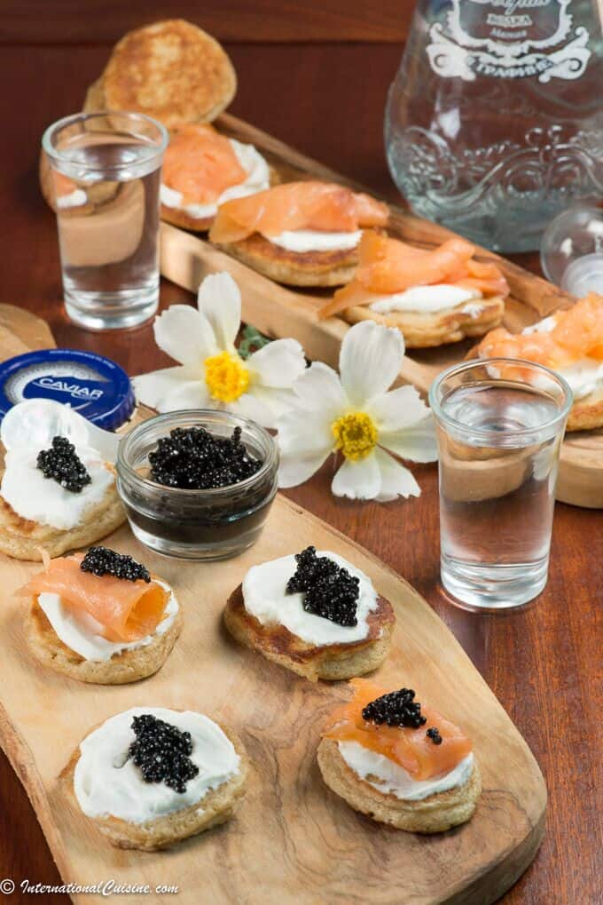 Russian Blinis with Sour Cream. Caviar and Salmon - International Cuisine