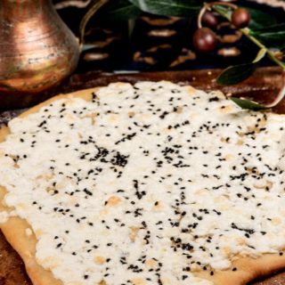 A flat bread with baked cheese and nigella seeds