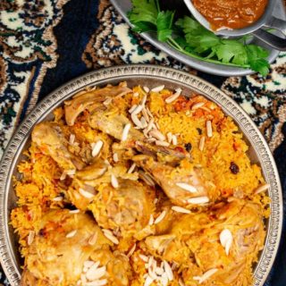 A platter filled with spiced rice and chicken a dish called Al Kabsa, the national dish of Saudi Arabia.