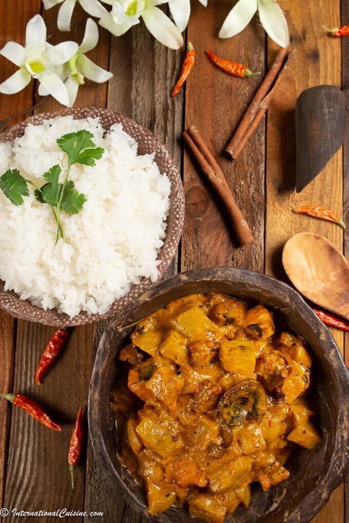 a bowl of octopus curry served with white rice