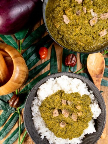 A platter of cassava leaf stew over rice.