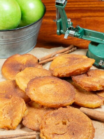 a bunch of fried apple slices topped with cinnamon and sugar.