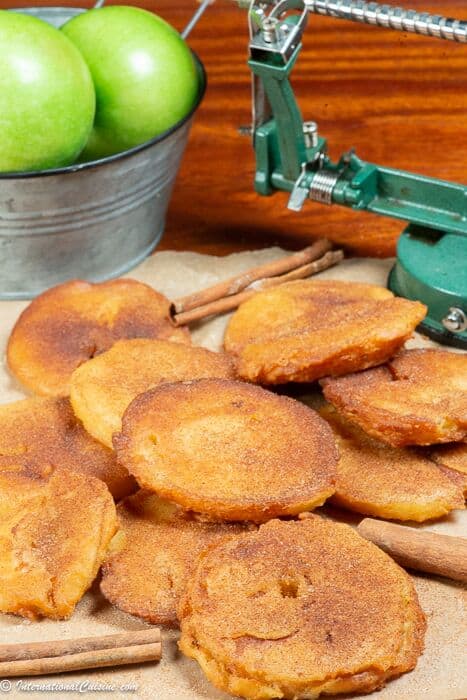 a bunch of fried apple slices topped with cinnamon and sugar. 