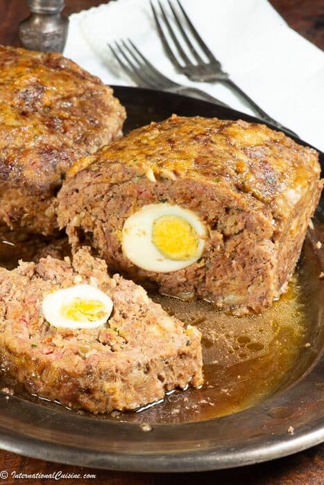 A meatloaf with hard boiled eggs in the middle.