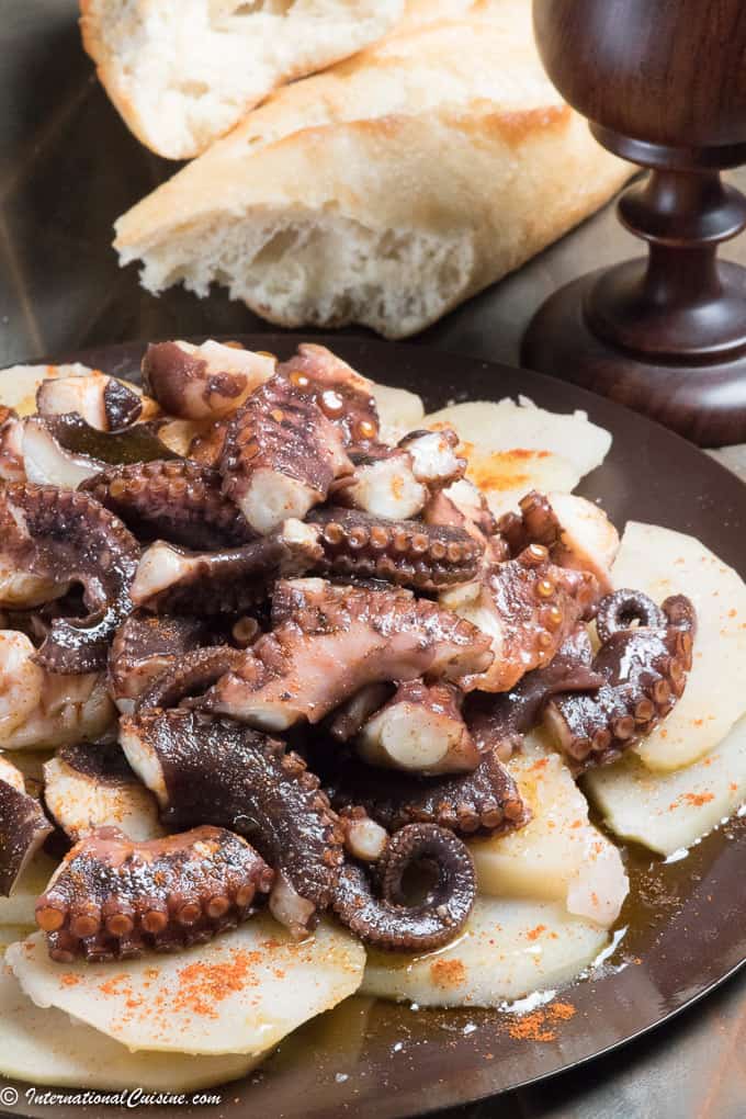 a plate with boiled potatoes topped with tender octopus