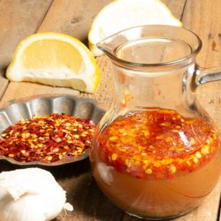 a container with a popular hot sauce in Sudan called shata it has hot chili flakes, garlic and lemons.