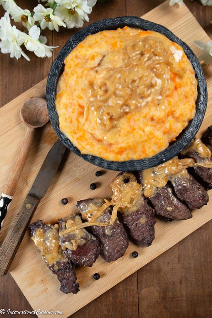 thin slices of ostrich steak with a cream sauce served with a pumpkin mash.