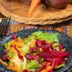 a salad with letttuce, beets and carrots