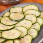 a plateful of thinly sliced pickled cucumbers called pressgurka in Sweden.
