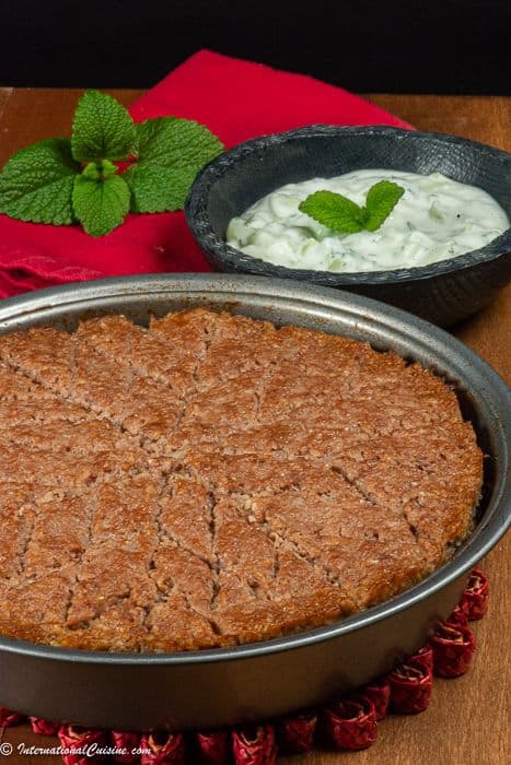 A baked lamb kibbeh cut into diamond pieces and served with greek yogurt.