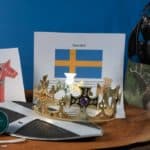Symbols of Sweden, the flag, dala horse, crown, viking ship a shield, caviar and a picture of an elk.