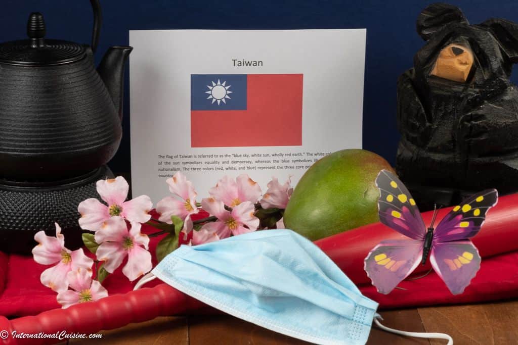 Symbols of Taiwan, a flag, plum blossoms, black bear, butterfly, baseball bat, teapot and a mask.