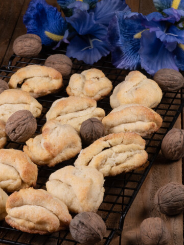a pan full of Tajikistan cookies garnished with walnuts.
