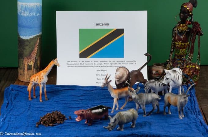 The Tanzanian flag with safari animal and a photo of mount Kilamajaro