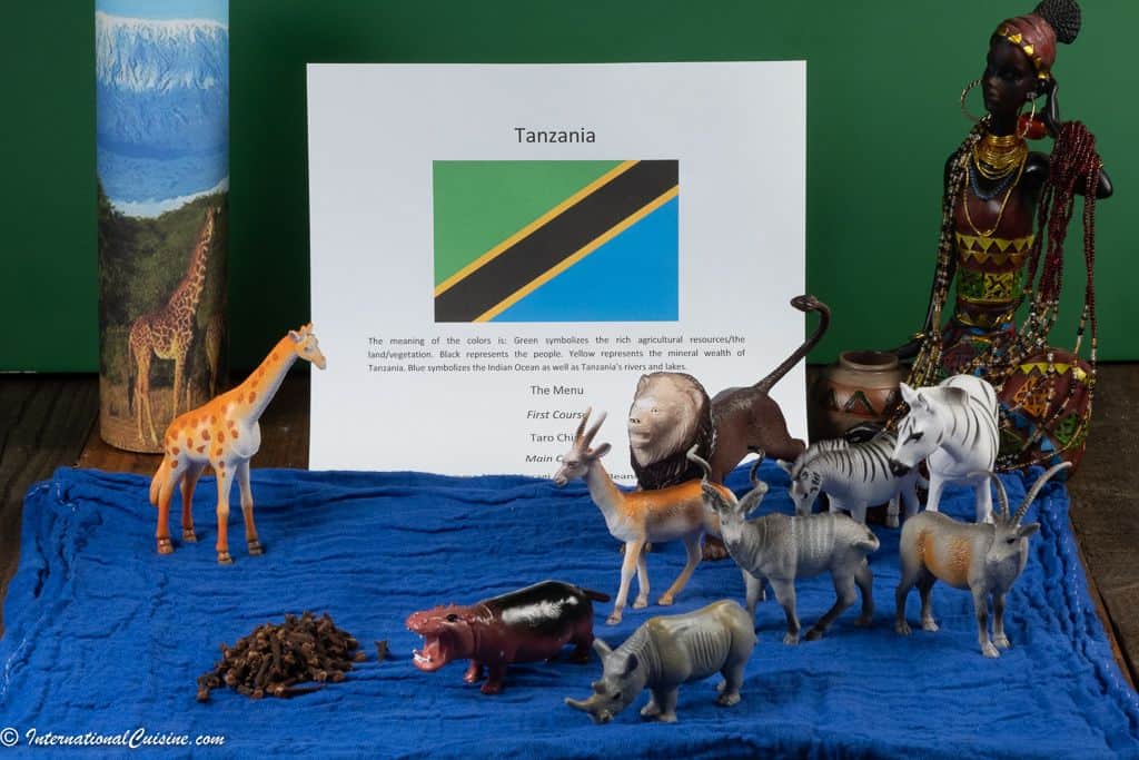 The Tanzanian flag with safari animals and a photo of mount Kilamajaro
