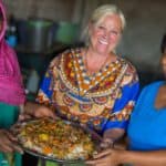 Darlene holding a dish made with Mama Naz and her daughter in law, in Arusha, Tanzania