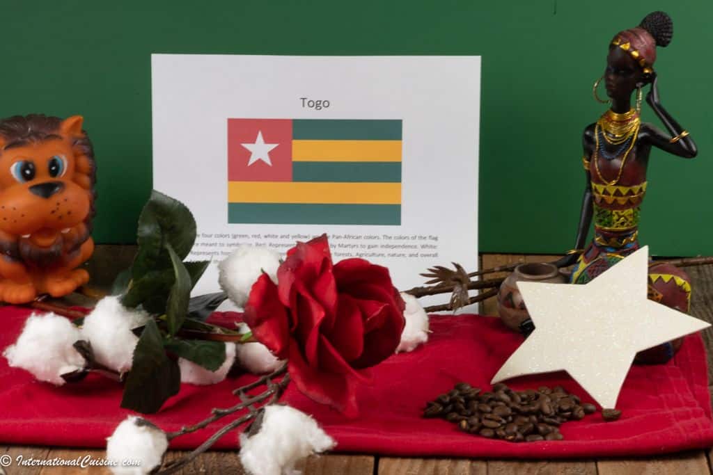 a photo that shows symbols of Togo their flag, a red rose, cotton and coffee beans