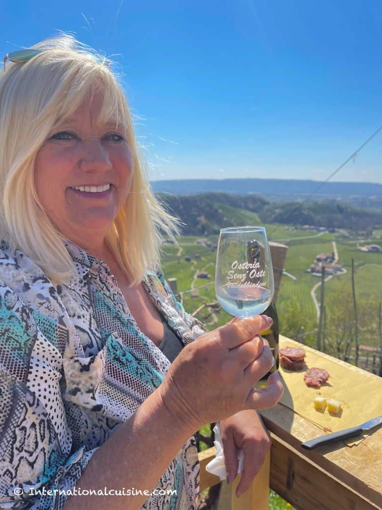 Darlene enjoying a glass of Prosecco overlooking the Prosecco Hills of Italy.