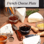 A artists palette filled with cheeses and jams