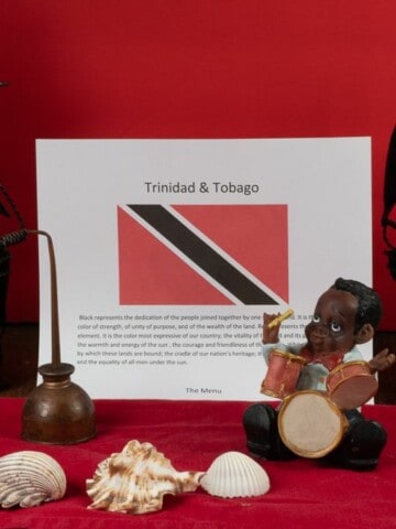 Items representing Trinidad and Tobago, their flag, ships, shells, a little drummer.