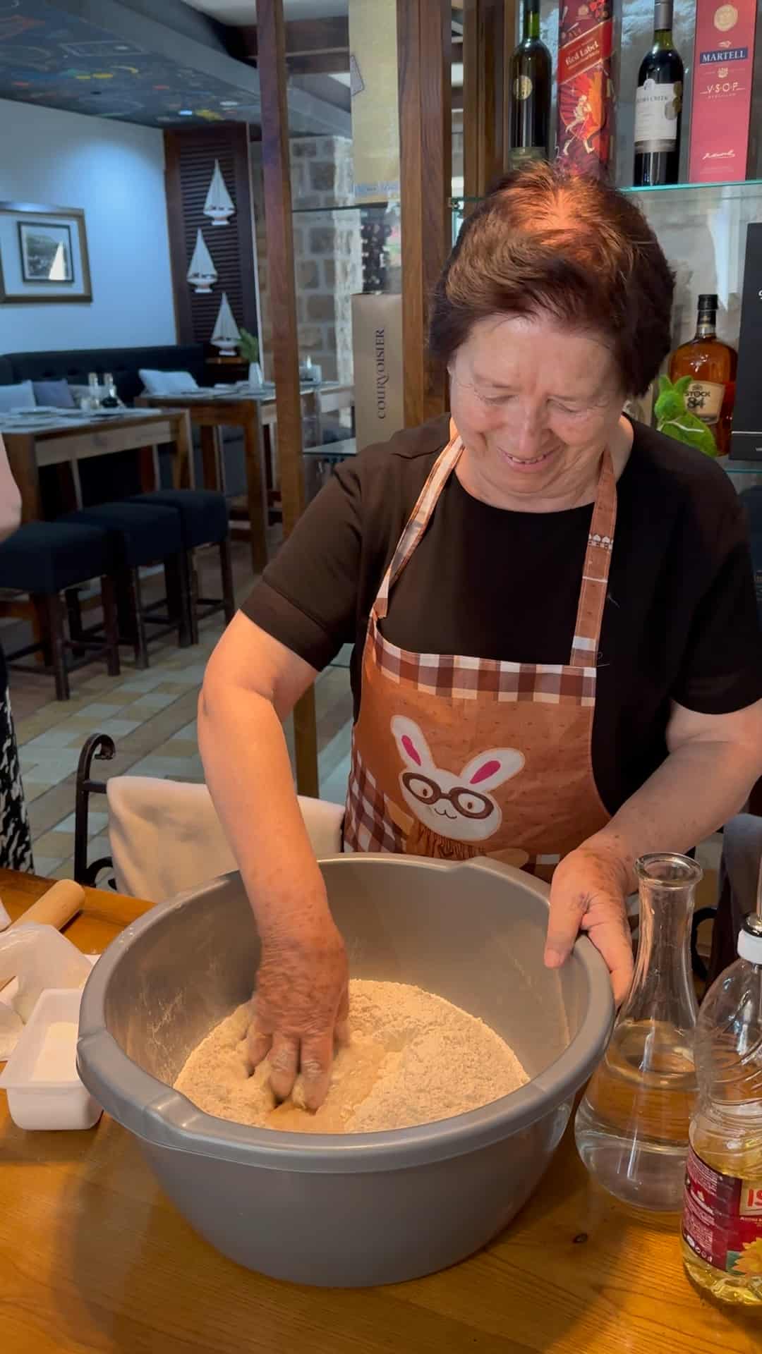 woman mixing the dough to make makarule.