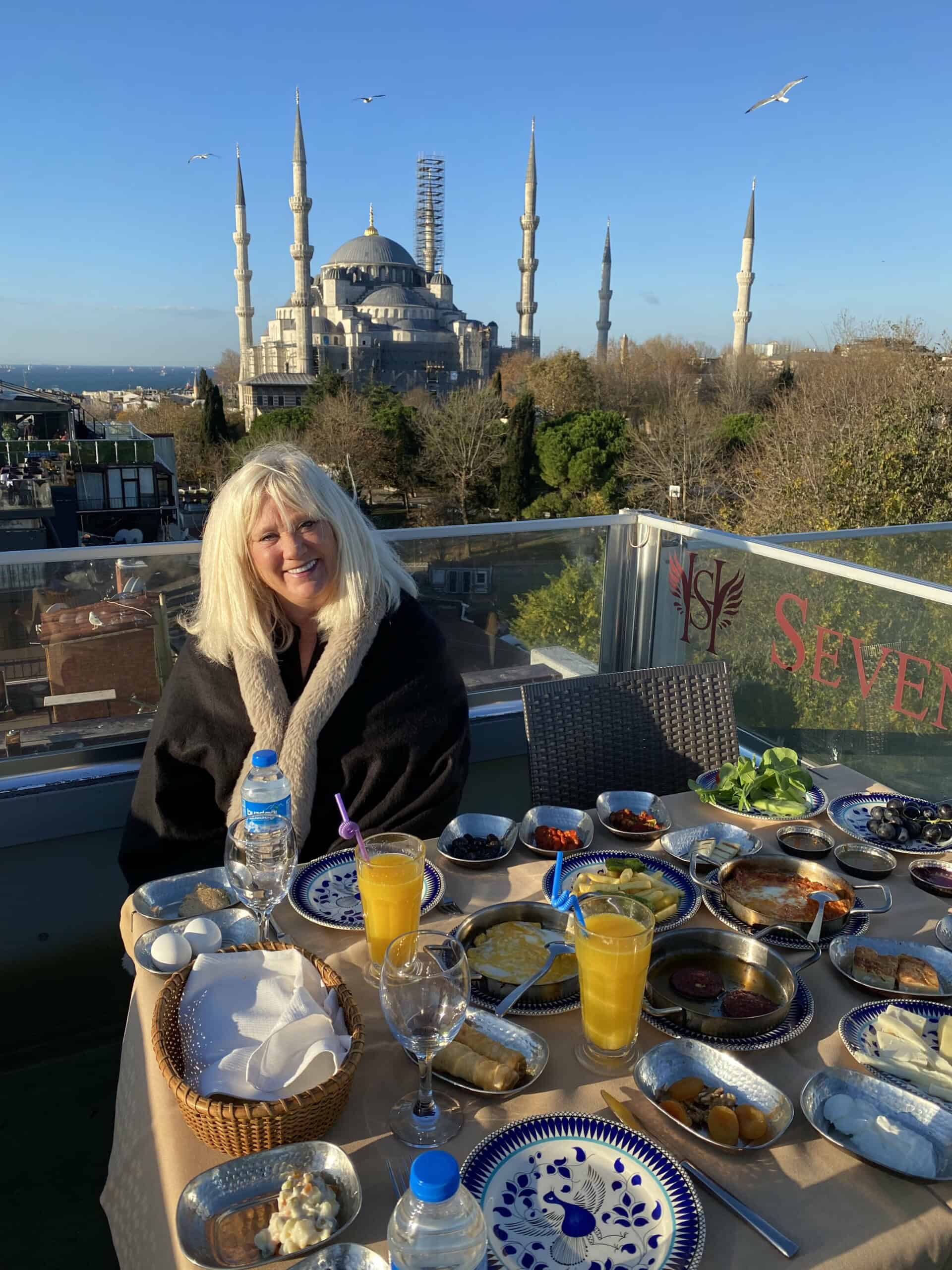 A breakfast table filled with maze in Istanbul with the Blue Mosque in the background and seagulls.
