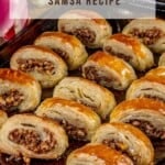 A tray of Turkish Samsa a puff pastry oozing with nuts and a sweet syrup sauce.