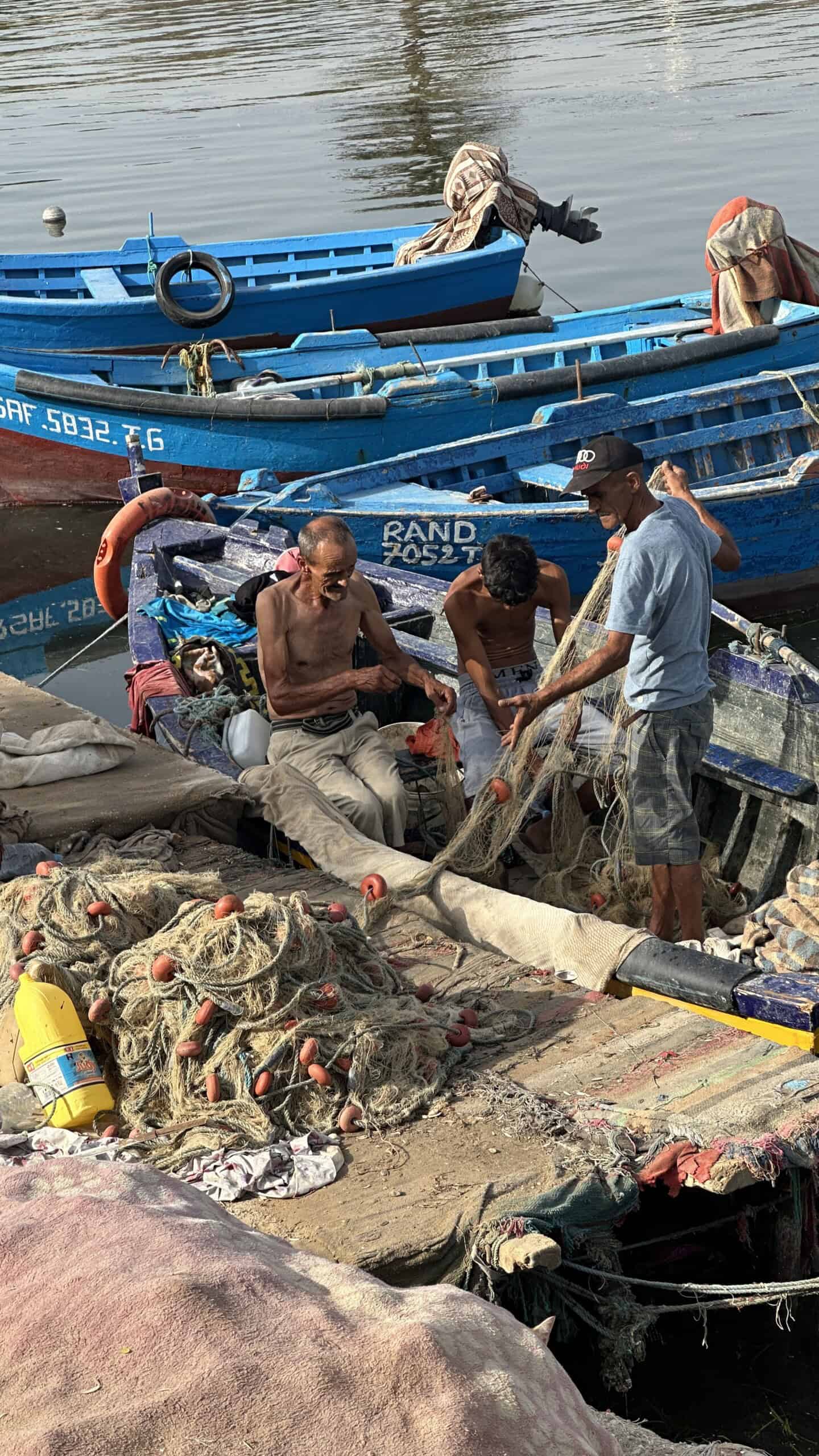 Fisherman in a wooden boat at the Punic Port in Carthage, Tunisia