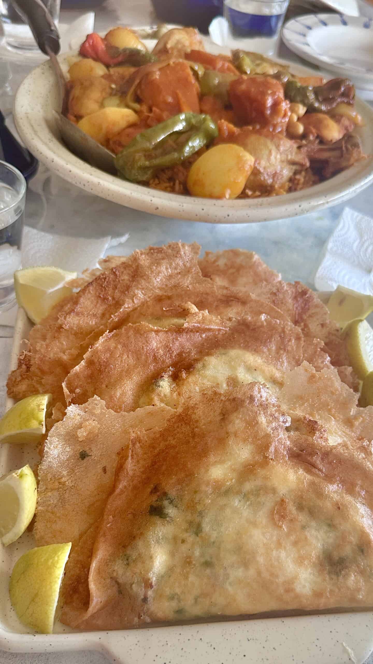homemade Tuniisian Brik served with lemon wedges and a platter of Dwinda.