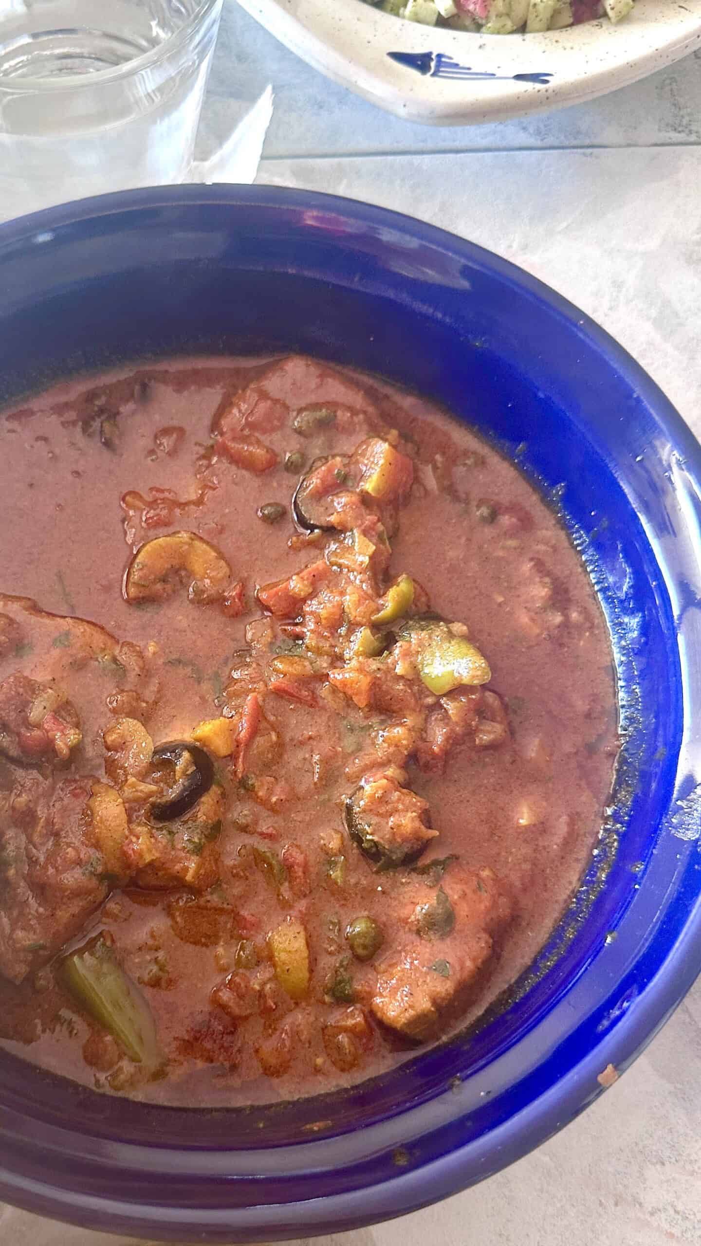 Tunisian Kabkabou with swordfish simmered in tomato sauce with olives, capers and preserved lemon.